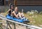 Middle-aged husband and wife having fun in a blue sled on a rollercoaster-like track in Vail, Colorado.