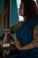 Middle-aged Indian woman holding an Indian musical instrument tanpura or sitar