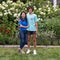 Middle-aged Korean mother and her Amerasian son posing before a bed of beautiful flowers in Bar Harbor, Maine.