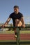 Middle-aged Latino athlete, warming up on the track