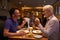 Middle aged male couple eating evening meal in a restaurant