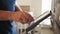 Middle-aged male scientist using a tablet in the laboratory. Close up of a doctor\'s hand using a touch monitor or