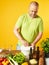 Middle-aged man cook fresh salad