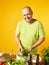 Middle-aged man cook fresh salad