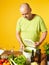 Middle-aged man cook fresh salad