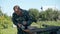 Middle-aged man cuts piece of long metal plank on old table