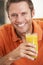 Middle Aged Man Drinking Fresh Orange Juice