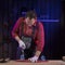 Middle-aged man in jumpsuit fixing plastic kids skateboard in home carpentry