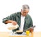 Middle Aged Man Pouring Milk into His Cereal Bowl
