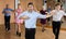 Middle aged man practicing ballroom dance pose in dance studio