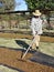 Middle-aged Man Raking Dried Sultanas.