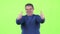 Middle aged man is showing a thumbs up. Green screen. Slow motion
