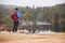 Middle aged man standing on a rock admiring the lakeside view, back view