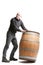 Middle-aged man tilting a wooden cask or barrel