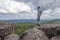 A middle-aged man at the top of the mountain enjoys a stunning view of the hilly valley. Freedom and goal achievement.