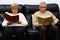 Middle-aged man and woman each reading a book