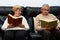 Middle-aged man and woman each reading a book