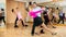Middle-aged pair practicing ballroom dance in dance studio