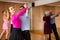 Middle-aged pair practicing ballroom dance in dance studio