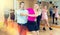 Middle-aged pair practicing Latino dance in dance studio