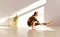 Middle-aged sportive active woman doing balance yoga exercise in light sunny studio