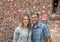 Middle-aged wife and husband in front of The Market Theater Gum Wall, Pike Place Market, Seattle, Washington