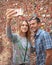 Middle-aged wife and husband taking a selfie in front of The Market Theater Gum Wall, Pike Place Market, Seattle, Washington