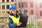 A middle-aged woman at a construction site works and checks