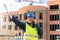 A middle-aged woman at a construction site works and checks