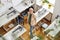 Middle aged woman designer looks at camera standing near sewing machines in spacious studio