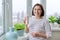 Middle-aged woman drinking dairy product, yogurt, milk in bottle