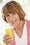 Middle Aged Woman Drinking Fresh Orange Juice