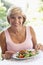 Middle Aged Woman Eating An Al Fresco Lunch