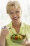 Middle Aged Woman Eating Fresh Salad