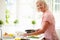 Middle Aged Woman Following Recipe On Digital Tabl