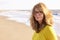 Middle aged woman with frizzy hair walking on the beach