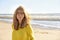 Middle aged woman with frizzy hair walking on the beach