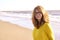 Middle aged woman with frizzy hair walking on the beach