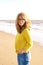 Middle aged woman with frizzy hair walking on the beach