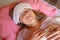 Middle aged woman has a fever or abnormal blood pressure. 40 years women lying in the bed with wet compress on a head. She is