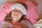 Middle aged woman has a fever or abnormal blood pressure. 40 years women lying in the bed with wet compress on a head. She is