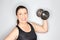 Middle aged woman lifting dumbbell