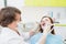 Middle aged woman patient at the dentist drilling the tooth with a turbine and making dental fillings