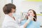 Middle aged woman patient at the dentist drilling the tooth with a turbine and making dental fillings