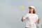 middle aged woman playing pickleball game over blue sky, pickleball yellow ball with paddle, outdoor sport leisure