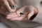 Middle aged woman pouring capsules pills out of plastic blister.