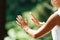 Middle Aged Woman Practicing Tai Chi Chuan in the Park. Close Up On Hands Position