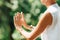 Middle Aged Woman Practicing Tai Chi Chuan in the Park. Close Up On Hands Position