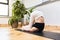 middle-aged woman practicing yoga in a nice studio. no recognizable face