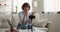 Middle-aged woman record videovlog using smart phone on tripod